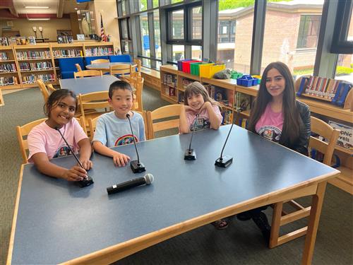 Kids and woman sitting at table