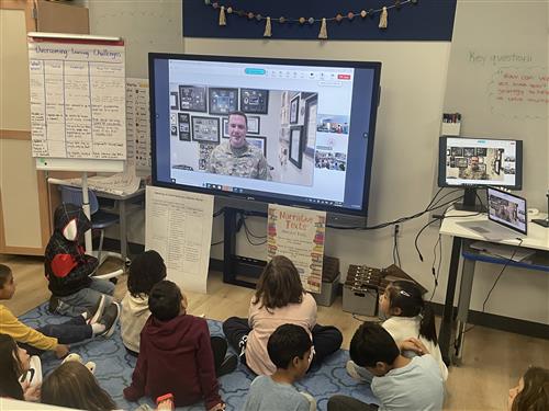 Children in classroom watch screen